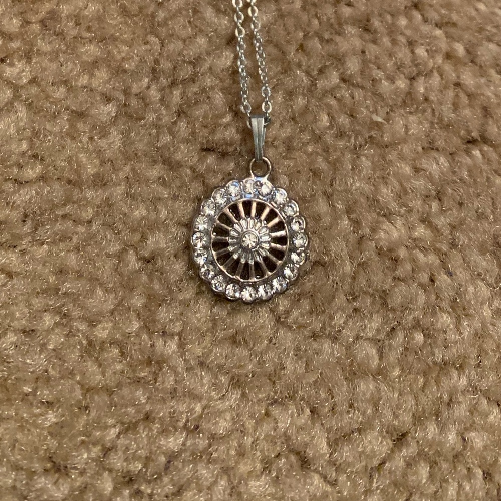 Silver wheel necklace.